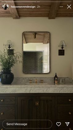 a bathroom vanity with two sinks and a large mirror