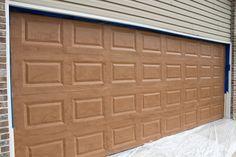 a garage door is being painted brown