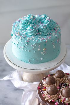 two cakes with frosting and sprinkles on top