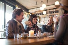 people sitting at a table drinking coffee and laughing in a restaurant stock photo getty images black bedroom furniture sets home design ideas