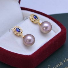 Make a lasting impression with the 11-12mm Freshwater Pearl & Blue Gem Cubic Zirconia Earrings-. These gorgeous earrings are set in a vintage-inspired silver alloy setting and feature shimmering white freshwater pearls and blue Cubic Zircoina gems. The combination of these two elements will bring a touch of elegance to any look, making them perfect for any occasion. Showcase your style and sophistication with this timeless piece from House of Pearls. This popular earrings design features AAAA qu Blue Pearl Earrings Fine Jewelry For Formal Events, Blue Pearl Earrings For Formal Occasions, Blue Pearl Earrings For Formal Events, Blue Round Pearl Earrings For Anniversary, Blue Pearl Earrings For Anniversary, Blue Pearl Earrings For Anniversary Fine Jewelry, Luxury Blue Pearl Drop Earrings, Luxury Blue Pearl Earrings For Anniversary, Elegant Blue Pearl Earrings For Anniversary