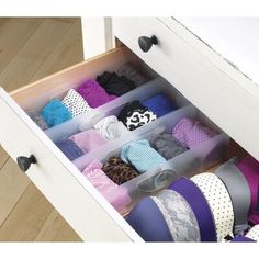 an open drawer with several pairs of socks in it