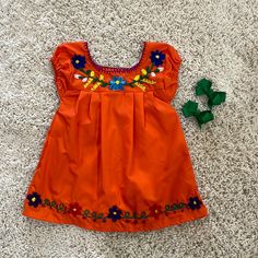 Beautiful Mexican Dress With Bows. Playful Orange Short Sleeve Dress, Orange Sleeveless Dress For Playtime, Casual Orange Playtime Dress, Casual Orange Dresses For Playtime, Casual Orange Dress For Playtime, Orange Cotton Playtime Dress, Playful Orange Cotton Dress, Cute Orange Cotton Dress, Baby Mexican Dress