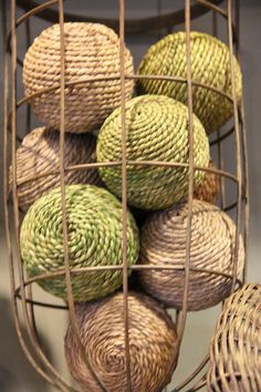 several balls of yarn are in a wire basket