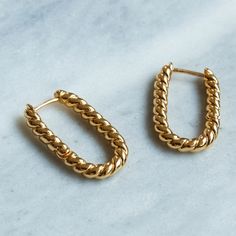 The perfect accessory for any outfit. Simple and stylish our Lilly Twisted Rectangular Gold Hoop Earrings are perfect for every day. Our sustainable  earrings are handmade with recycled brass dipped in thick layers of recycled 14 Carat Gold. Please note each product is made by hand, there may be slight natural variations in the length or tone of pieces. Humidity is the enemy; keep it dry! Store your goodies individually in the pouch included with your purchase. Avoid rough wear to slow down the Hoop Earrings Handmade, Thick Layers, Outfit Simple, Handmade Fine Jewelry, Ethical Jewelry, Demi Fine Jewelry, Sustainable Jewelry, Oils For Skin, Polish Jewelry