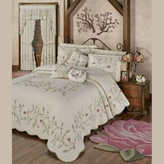 a bed room with a neatly made bed and flowers on the bedspread in it