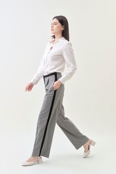 Combining classic tailoring with modern details, our Pleated Wide Pant offers an effortlessly sophisticated silhouette. With a comfortable mid-rise and a pleated wide fit, pair it with our Classic Blazer for a luxe statement. Details Hidden hook-and-bar closure Comfortable mid-rise Wide trouser fit, regular length Side pockets Contrast stripe detail Houndstooth suiting fabric upcycled from premium deadstock Machine washable Casual Wide Leg Pants With Straight Hem For Office, Elegant Relaxed Fit Wide Leg Work Pants, Modern Tailored Dress Pants For Office, Elegant Wide Leg Work Pants With Relaxed Fit, Elegant Relaxed Fit Dress Pants For Semi-formal Occasions, Elegant Semi-formal Pants With Relaxed Fit, Elegant Semi-formal Relaxed Fit Pants, Classic Houndstooth Pattern Bottoms, Elegant Relaxed Fit Dress Pants For Office