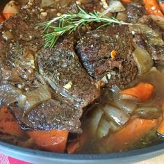 a pot filled with meat and vegetables on top of a table