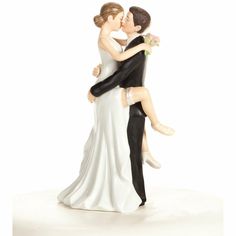 a bride and groom figurine hugging each other