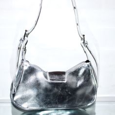 Wear this studded decorated eyelet buckle shoulder bag to any casual look for a pop of detail in accessories. PRODUCT DETAILS: Hobo Bag Zipper closure Buckle closure Material: PU Leather Measurements: 11 (L) x 2.8 (W) x 5.9 (H) Silver Prices, Casual Look, Hobo Bag, Casual Looks, Metallic Silver, Pu Leather, Buckle, Shoulder Bag, Zipper