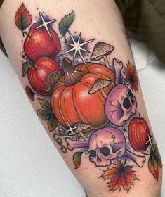 an apple, tomato and skull tattoo on the leg is shown in this image with stars