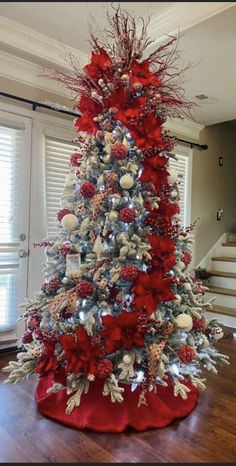 a christmas tree decorated with red and silver ornaments