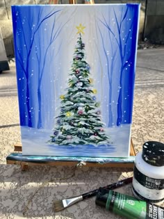 a christmas tree is painted on a easel