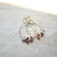 Triple Puka Shell Hoops, handmade with aloha in Kailua-Kona Hawaii. These unique earrings feature tiny puka shells strung onto gold filled hammered hoops. Experience the island vibes and add a touch of playfulness to your look! Made in Kailua-Kona, on the Big Island of Hawaii Gold filled hoop earrings Puka shells Made from 20g wire and measures approximately 28mm. Shell Hoop Earrings, Big Island Of Hawaii, Geek Design, Island Of Hawaii, Kailua Kona, Puka Shell, The Big Island, Sea Glass Earrings, Gold Filled Hoops