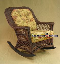 a wicker rocking chair with floral cushions