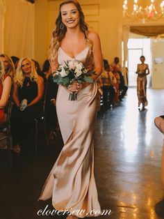 a woman in a long dress walking down the aisle