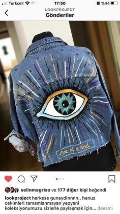 a denim jacket with an eye painted on it