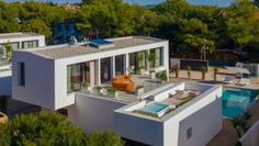 an aerial view of a modern house with pool