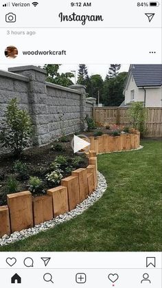 an instagram photo of a garden with wooden planters in the middle and landscaping around it