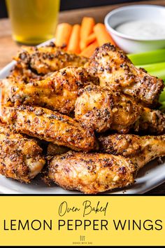 chicken wings with lemon pepper and celery on a white plate next to carrots and celery sticks