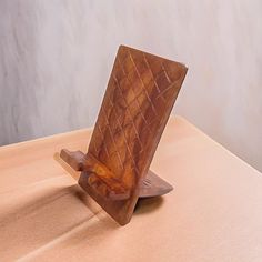 a wooden stand with a piece of wood sticking out of it's side on top of a table