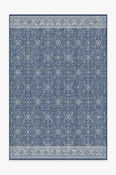 a blue and white rug with an intricate design