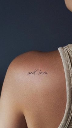 the back of a woman's shoulder with an inscription on it that says self love