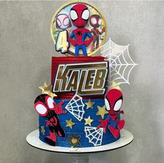 a spiderman birthday cake with the name kaleb on it and some decorations