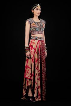 Multi color flared printed trouser with embellished waist band. Paired with multi color blouse, featuring exquisite embroidery, including resham thread work, mirror and beads.
Component: 2
Embroidered, Printed
Neckline: Square
Sleeve Length: Cap
Fabric: Kurta: Cotton; Trouser: Natural Crepe
Color: Multi Color, Red
Deep back neck with tassel tie-ups
Elasticated back waist band trouser
Asymmetric hem trouser
Note: The dupatta worn by the model is for styling purpose only - Aza Fashions Red Choli With Printed Motifs In Traditional Drape, Red Choli With Printed Motifs And Traditional Drape, Red Festive Blouse With Printed Motifs, Red Fitted Choli With Printed Motifs, Fitted Red Choli With Printed Motifs, Fitted Red Palazzo Set With Printed Motifs, Festive Red Blouse With Printed Motifs, Red Anarkali Sharara With Kalamkari Print, Red Bohemian Floor-length Sharara