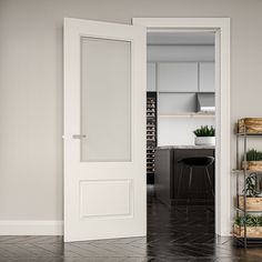 an open door leading to a kitchen and living room with potted plants on shelves