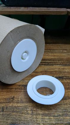 a roll of toilet paper sitting on top of a wooden table