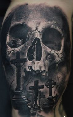 a man with a skull and cross tattoo on his back, in black and white