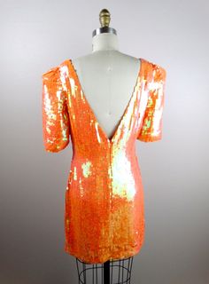 "An absolutely breathtaking color! This beauty is fully embellished with iridescent orange sequins and in perfect condition! Measurements: Bust - 32/34\" Waist - 27\" Hips - 36\" Dress Length - 32\" This amazing dress comes from a pet-free and smoke-free home. If you would like more info or have any questions, please ask!" Elegant Orange Sequin Dress, Orange Evening Dress For Party Season, Embellished Orange Evening Dresses, Glamorous Fitted Orange Dress, Glamorous Orange Evening Dress, Orange Sequined Dress For Party, Glamorous Orange Wedding Dress, Orange Sequined Summer Dress, Orange Sequin Summer Dress