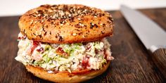 a bagel sandwich sitting on top of a wooden table