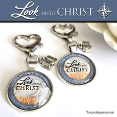 two keychains with the words look into christ and an image of a polar bear