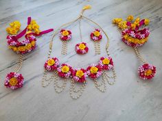 This is 4 pieces jewellery set contains following : - Earrings pair (1) - Tikka (1) - Hathphool/Handcuffs pair (1) - Necklace/Choker (1) Note : Buyer country all TAXES & CUSTOM DUTY will be paid by buyer.           : Color may be vary because of camera flash & different computer screens. VividFlora Floral Jewellery :  Adorn yourself with the beauty of nature with our delicate floral jewelry. Featuring intricate designs inspired by blooming flowers, this jewelry will add a touch of elegance to an Traditional Jewelry With Flower Decoration For Celebration, Festive Jewelry With Flower Decoration For Festivals, Flower Decorated Jewelry For Weddings And Festivals, Multicolor Flower Decorated Jewelry For Weddings, Yellow Kundan Necklace For Wedding, Festive Flower Decorated Jewelry For Festivals, Yellow Tilla Jewelry For Wedding, Festive Gold Jewelry With Flower Decoration, Peach Jewelry