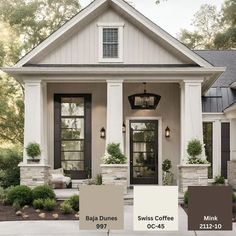 the exterior of a house with white trim and black shutters, brown doors, and gray