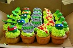 a box filled with cupcakes covered in green frosting and teenage mutant decorations