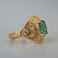 Introducing the "Emerald Scarab Ring" – a captivating blend of ancient Egyptian mystique and timeless elegance. Centered with a lush emerald framed by intricate Islamic patterns inspired by Egypt's architectural wonders, this ring evokes the opulence of ancient Egypt. Flanked by scarabs symbolizing rebirth, each holds a radiant diamond, echoing the sun's eternal sparkle on the Nile's waters. All orders come in our Tippy Taste ring box. This ring is handmade and designed in NYC. 14K or 18K solid gold Natural oval emerald, 8*6mm, approx. 1.20ct Natural round diamonds. SI clarity, GH color, 0.06ct total carat weight 3mm ring band ** Tippy Taste Heirloom Collection is made to order. Please allow 3-4 week turnaround time. Shipping:Domestic: Free shippingInternational: Free shippingAll orders ar