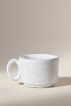 a white cup sitting on top of a table