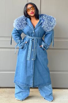 Description: Turn heads in this luxury Trench coat, crafted out of a mid weight denim fabric with an oversized fit. This coat features an exquisite exaggerated detachable mongolian fur collar. The trench is complete with a front button closure, detachable waist belt and side pockets, creating a sophisticated and stylish silhouette. The shoulder epaulettes can be fastened or unsnapped for added versatility. This outerwear is sure to keep looking chic and polished. PRE ORDER, ESTIMATED SHIP DATE 9/15-9/21. RESERVE YOURS NOW. 100% Cotton, 100% Mongolian Fur Medium denim wash. Measurements guide: This coat as an oversized fit. Product Measurements Length Bust Label Size US Size IN IN S 4-6 49.80 40.16 M 8 50.39 41.73 L 10 50.98 44.88 XL 12-14 51.57 48.03 2XL 14-16 52.17 51.18 3XL 16-18 52.76 5 Western Chic Outfits, Denim Trench Coat, Blue Trench Coat, African Girl, Embellished Jeans, Western Chic, Fur Collars, Denim Fabric, Denim Wash