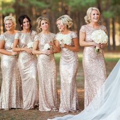 the bride and her bridesmaids are all dressed in gold sequin gowns