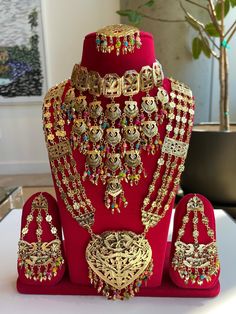 This traditional Indian/Punjabi Jewelry Set features beautiful long Gold Necklace, layered choker style necklace, tikka and earrings embellished with multicolor beads SIZES: Long Necklace: 14.5 inches long (can be adjusted longer) - Pendant size: 3 inches wide, 3.5 inches wide Layered Choker Necklace: 6 inches long, 10 inches wide across neck (can be adjusted for wider neck) Earrings: 4 inches long, 2.5 inches wide Tikka: 6 inches long Please allow up to 0.5" difference due to hand measurement Bohemian Gold Bridal Necklace With Cutdana, Bohemian Wedding Sets With Latkans, Gold Kundan Sets For Traditional Ceremonies, Bollywood Style Jewelry Sets For Navratri Ceremonial Occasions, Bollywood Style Jewelry Sets For Navratri Ceremonial, Bollywood Ceremonial Jewelry Sets For Navratri, Bollywood Style Jewelry Sets For Navratri Ceremonies, Bollywood Style Ceremonial Jewelry Sets For Navratri, Heavy Jewelry For Traditional Festive Ceremonies