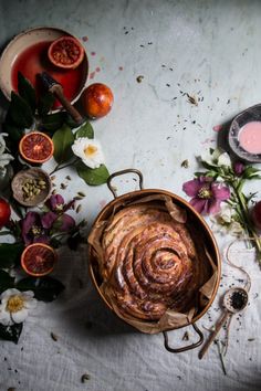 an overhead view of some food on a table with flowers and other things around it