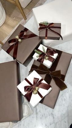 four wrapped presents sitting on top of a table