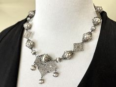 A striking Medieval, Viking, Victorian, Gothic, Vampire, or Renaissance statement necklace, this beautiful, handmade, one-of-a-kind vintage silver-look/gunmetal/hematite filigree beaded necklace is reminiscent of dragon scales with 2 sizes of white glass pearls, bead caps, and fancy links.  Perfect for Medieval Feasts and Renaissance Faires, or Renaissance and Vintage-themed weddings!  Once the festivities are over, this versatile necklace can take you through Halloween, Christmas, and New Year's Eve. Gorgeous against jewel tones like garnet, emerald, and sapphire blue, it also looks lovely against black, white, and charcoal gray. Measures 18" long. Closes with lobster claw clasp. Lightweight necklace for all-day wear.  Currently working on dangle earrings to go with the necklace! :)  ♔ Se Silver Engraved Necklace For Party, Ornate Silver Necklace For Party, Unique Filigree Necklace For Weddings, Unique Filigree Wedding Necklace, Unique Metal Filigree Necklaces, Unique Metal Necklace With Filigree Details, Unique Metal Filigree Necklace, Vintage Oxidized Necklace For Party, Vintage Oxidized Finish Necklace For Party