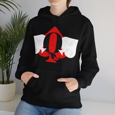 a woman wearing a black hoodie with the letter q on it