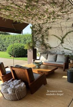 an outdoor living area with couches and tables