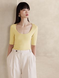 We opted for a body-hugging compact knit for this sleek scoop-neck top, employing a half-Milano stitch to add soft structure.  Crafted in one of our favorite all-season yarns.  Fitted.  Scoop neck.  Straight hem.  Fitted.  Elbow sleeves.  Hip length.  Model: Size S, 5'10" (178cm). Vanilla Custard, Top Banana, Round Face Haircuts, Butter Yellow, Light Spring, Scoop Neck Top, Elbow Sleeve, Round Face, Hip Length