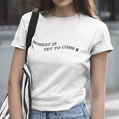 New! Moment Is Yet To Come Lettering With Bts Logo Waved Across Chest. Mens/Unisex Cut And Sizing For Comfortable Fit. 100% Cotton. Crew Neck. Short Sleeves. White Color With Black Design. (Shirt Will Not Come With Sleeves Cuffed. Pants And Accessories Not Included.) Check Out More Bts And Bt21 Items In My Closet! # Proof, New Song, Lyrics, Quote, K-Pop, Boy Band, Bt21, Concert, Party, Fandom, Group, Jin, Suga, J-Hope, Rm, Jimin, V, Jungkook, Korean, Bangtan Boys, Love Yourself, Butter, Custom, Simple Letter Print T-shirt For Spring, Simple Streetwear Tops With Letter Print, Moment Is Yet To Come, New Song Lyrics, Bts Logo, Concert Party, Rm Jimin, Bts Shirt, Swiftly Tech Short Sleeve